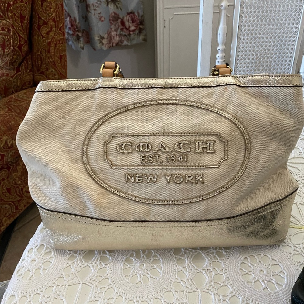 Lovely coach purse with gold accents so pretty  inside is plaid material.